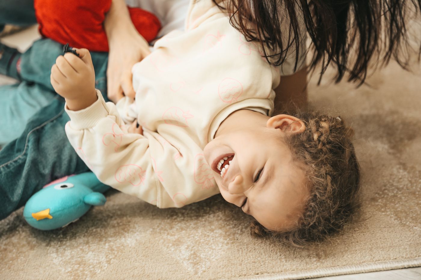 A parent and child smiling together